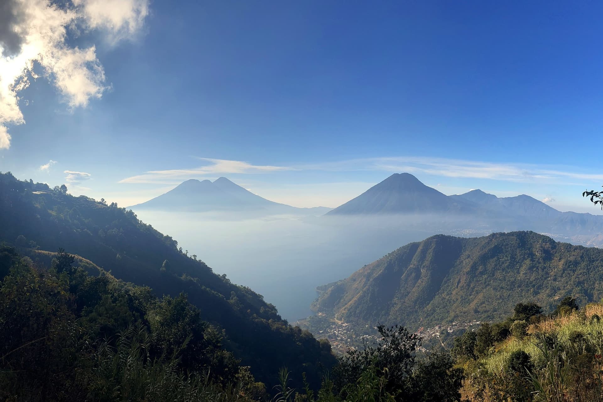 Early light breaking over the volcanoes across Lake Atitlán, seen from the hillside