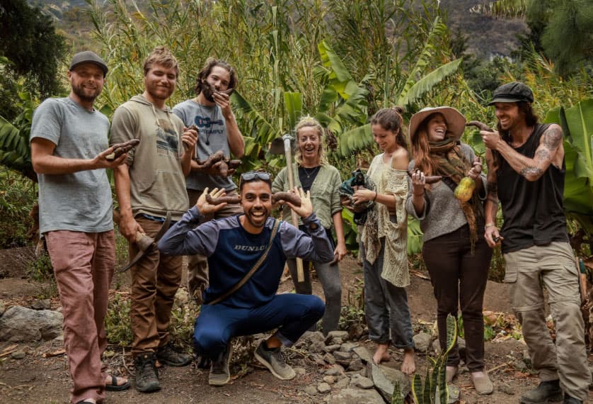 Permaculture students harvesting sweet potatoes at Granja Tz’ikin
