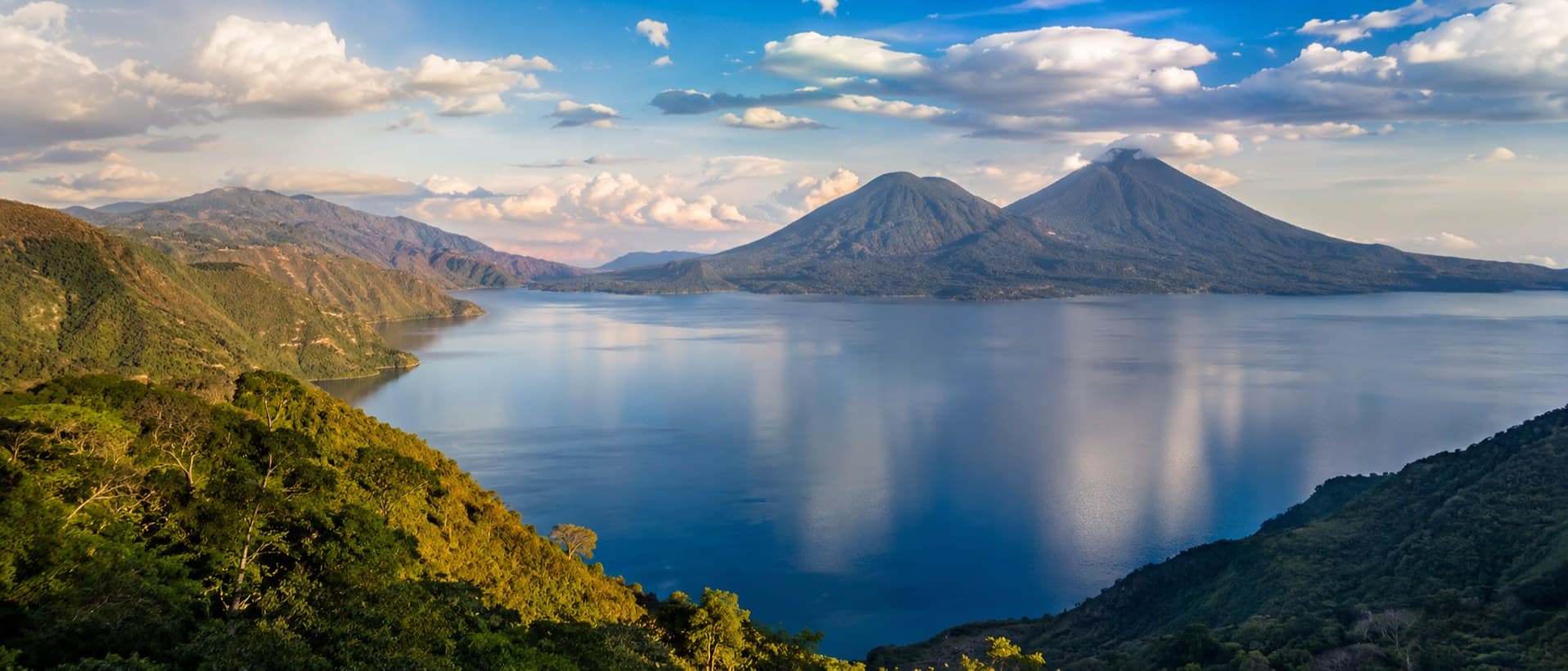 Lake Atitlán ringed by volcanoes at sunset
