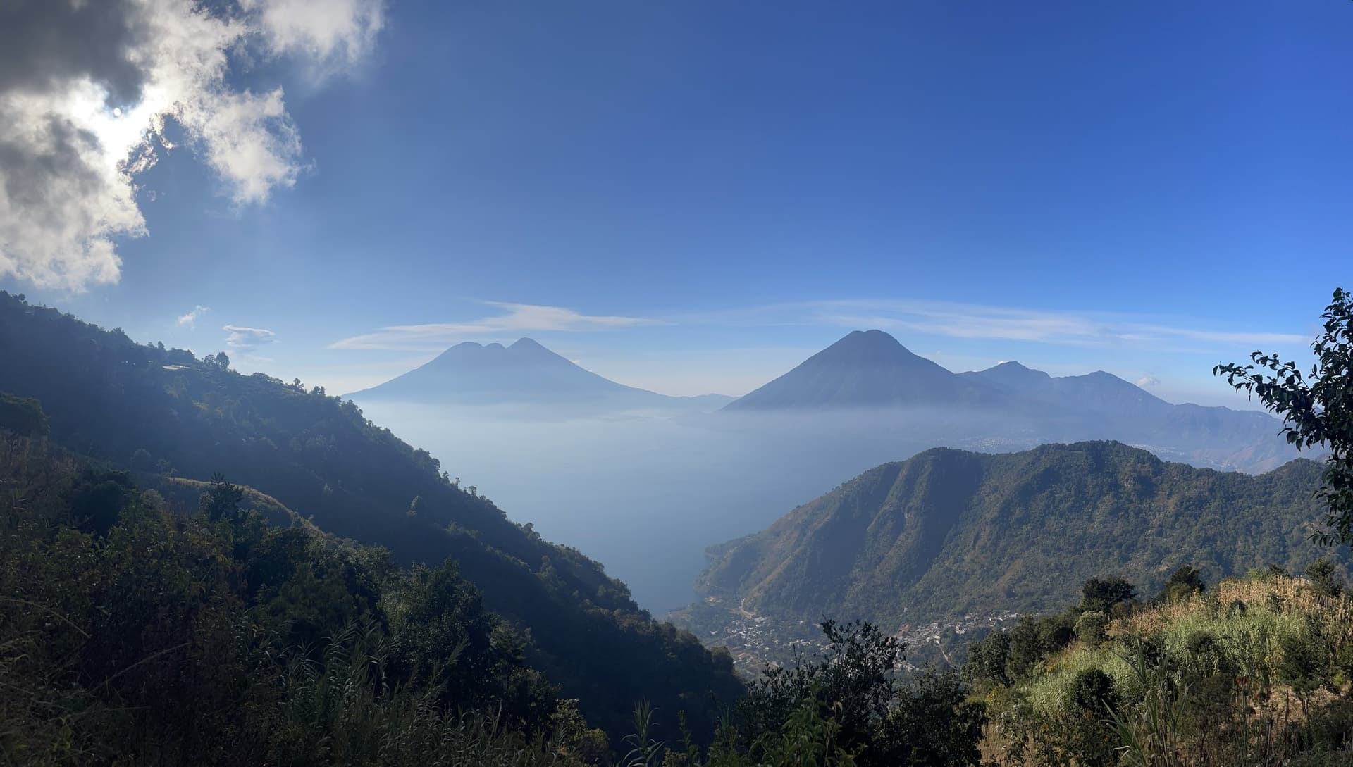 Lake Atitlán and its volcanoes seen from the ridge above Tzununá, early morning